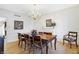 Formal dining room features a wooden table, chandelier, and white wainscoting at 13827 Driftwood Dr, Carmel, IN 46033