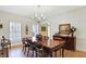 Dining area showcasing a wooden table, chandelier, and shuttered windows at 13827 Driftwood Dr, Carmel, IN 46033
