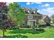 Elegant brick home with lush landscaping, and well-maintained lawn at 13827 Driftwood Dr, Carmel, IN 46033