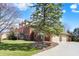 Spacious brick home with a three car garage, green lawn, and mature trees at 13827 Driftwood Dr, Carmel, IN 46033