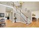 Grand foyer with hardwood floors, staircase, chandelier, and high ceilings at 13827 Driftwood Dr, Carmel, IN 46033