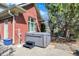 Backyard patio view of hot tub near a red brick house with a stepping stool and lush trees at 13827 Driftwood Dr, Carmel, IN 46033
