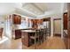 Updated kitchen with dark wood cabinetry, a center island, and stainless steel appliances at 13827 Driftwood Dr, Carmel, IN 46033