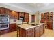 Spacious kitchen with wood cabinets, granite countertops and stainless steel appliances at 13827 Driftwood Dr, Carmel, IN 46033