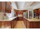 Updated kitchen with wood cabinets, stainless appliances, granite counters, and hardwood flooring at 13827 Driftwood Dr, Carmel, IN 46033