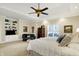 Cozy bedroom featuring trey ceiling, seating area, and custom built-in shelving at 13827 Driftwood Dr, Carmel, IN 46033