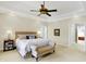Comfortable bedroom with trey ceiling, neutral colors, and a seating bench at 13827 Driftwood Dr, Carmel, IN 46033