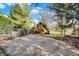 View of backyard playground with slide, climbing structure, and wood chip ground cover, surrounded by trees at 13827 Driftwood Dr, Carmel, IN 46033