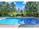 Inviting in-ground pool with lush landscaping and a basketball hoop, perfect for summer fun at 13827 Driftwood Dr, Carmel, IN 46033