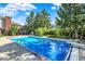 Beautiful in-ground pool with diving board, surrounded by trees, offering a refreshing escape at 13827 Driftwood Dr, Carmel, IN 46033