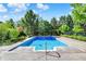 Inviting outdoor swimming pool surrounded by lush greenery, plants and trees for privacy at 13827 Driftwood Dr, Carmel, IN 46033