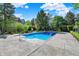 Backyard pool with expansive concrete patio, ideal for entertaining and relaxation at 13827 Driftwood Dr, Carmel, IN 46033