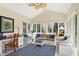 Inviting sunroom with vaulted ceiling, wicker furniture, and many windows looking out to the backyard at 13827 Driftwood Dr, Carmel, IN 46033