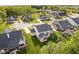 Eye-level aerial view presents the back of a suburban property with mature trees and a picturesque pond at 14003 Grannan Ln, Carmel, IN 46074