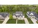 Stunning aerial view of a well-maintained suburban home with a landscaped yard and mature trees at 14003 Grannan Ln, Carmel, IN 46074