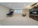 Finished basement area featuring a decorative fireplace and ample space for recreation at 14003 Grannan Ln, Carmel, IN 46074