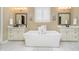 Bright bathroom with marble floors, soaking tub, double sinks, and modern fixtures at 14003 Grannan Ln, Carmel, IN 46074