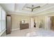 Neutral bedroom with double-tray ceiling, dresser, and view into the hallway for a sense of openness at 14003 Grannan Ln, Carmel, IN 46074