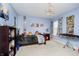 bedroom featuring blue walls, comic art, a modern light, and toys at 14003 Grannan Ln, Carmel, IN 46074