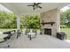 Covered patio featuring a brick fireplace and outdoor seating for relaxing and entertaining at 14003 Grannan Ln, Carmel, IN 46074