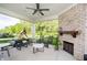 Relaxing covered patio featuring a fireplace, seating and play area at 14003 Grannan Ln, Carmel, IN 46074