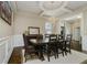 Elegant dining room featuring a chandelier, coffered ceiling, wainscoting, and a wooden table set at 14003 Grannan Ln, Carmel, IN 46074