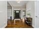 Inviting foyer featuring dark wood floors, a decorative table, and a front door with glass panels at 14003 Grannan Ln, Carmel, IN 46074