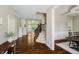 Spacious hallway showcasing hardwood floors, staircase with carpet, and an open view of the living room at 14003 Grannan Ln, Carmel, IN 46074