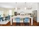 Bright kitchen boasts a granite-topped island with seating, modern stainless appliances, and an adjacent breakfast nook at 14003 Grannan Ln, Carmel, IN 46074