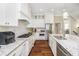 This kitchen boasts granite countertops, subway tile backsplash, stainless steel appliances, and a large island at 14003 Grannan Ln, Carmel, IN 46074
