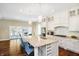 Bright kitchen with granite counters, stainless appliances, an island with seating, and access to an outdoor patio at 14003 Grannan Ln, Carmel, IN 46074