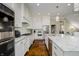 Bright kitchen featuring white cabinets, granite countertops, stainless steel appliances, and an island sink at 14003 Grannan Ln, Carmel, IN 46074