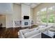 Spacious living room features soaring ceilings, a decorative fireplace, built-in shelving, and large windows at 14003 Grannan Ln, Carmel, IN 46074