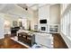 Open living room with a fireplace, built-in shelving, and hardwood floors offering modern elegance at 14003 Grannan Ln, Carmel, IN 46074