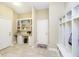 Neutral mudroom with tile floors, desk and bookcase, hall tree, and access to a second door to the outside at 14003 Grannan Ln, Carmel, IN 46074