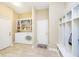 Beautful mudroom with washer, dryer, built-in bookcase, storage cubbies, and light neutral-colored walls at 14003 Grannan Ln, Carmel, IN 46074