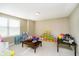 Spacious playroom with a window, toy storage, and carpet floors at 14003 Grannan Ln, Carmel, IN 46074
