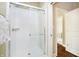 Walk-in shower enclosed with clear glass has white subway tile and modern fixtures, plus a view of the hall at 14003 Grannan Ln, Carmel, IN 46074