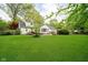 Backyard is beautifully landscaped and includes a patio and a fire pit at 1409 Alimingo Dr, Indianapolis, IN 46260