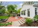 Inviting backyard patio features brick paving, outdoor seating, and lush landscaping at 1409 Alimingo Dr, Indianapolis, IN 46260