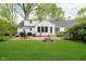Large backyard with a brick patio, a fire pit, and plenty of green space at 1409 Alimingo Dr, Indianapolis, IN 46260