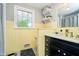 Bathroom boasts classic yellow tile and a sleek black vanity with ample counter space at 1409 Alimingo Dr, Indianapolis, IN 46260
