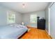 Bedroom has a cozy atmosphere with neutral colors, hardwood floors, and natural light at 1409 Alimingo Dr, Indianapolis, IN 46260