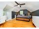 Cozy bedroom featuring a ceiling fan, hardwood floors, and a calming color scheme at 1409 Alimingo Dr, Indianapolis, IN 46260