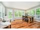 Bright dining area with lots of natural light, a rustic table, and access to the backyard at 1409 Alimingo Dr, Indianapolis, IN 46260