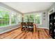 Sunlit dining area featuring a wooden table, and large windows showcasing the outdoor scenery at 1409 Alimingo Dr, Indianapolis, IN 46260