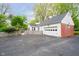Garage and driveway provide ample parking space and complement the well-maintained home at 1409 Alimingo Dr, Indianapolis, IN 46260