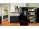 Kitchen featuring black cabinets, stainless steel appliances, and open shelving at 1409 Alimingo Dr, Indianapolis, IN 46260