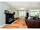 Comfortable living room with a fireplace, hardwood floors, natural light, and stylish decor at 1409 Alimingo Dr, Indianapolis, IN 46260