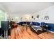 Inviting living room with wood floors, comfortable leather seating, and natural light at 1409 Alimingo Dr, Indianapolis, IN 46260